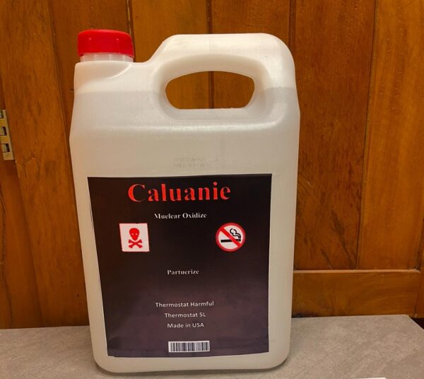 Caluanie chemical, a highly corrosive and toxic substance, displayed in a clear plastic container with a bright blue liquid inside. The label on the bottle indicates its hazardous nature, often used in industrial processes, and accompanied by warning symbols for safety precautions